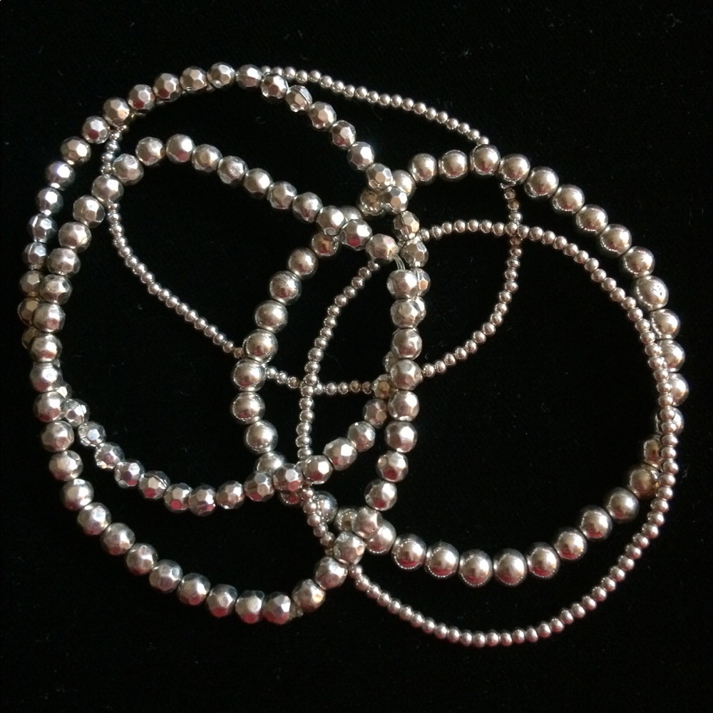 Set of five silver ball bracelets.